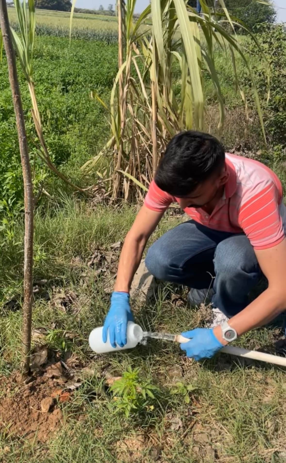 Parth collecting a water sample from a village pipe in Punjab